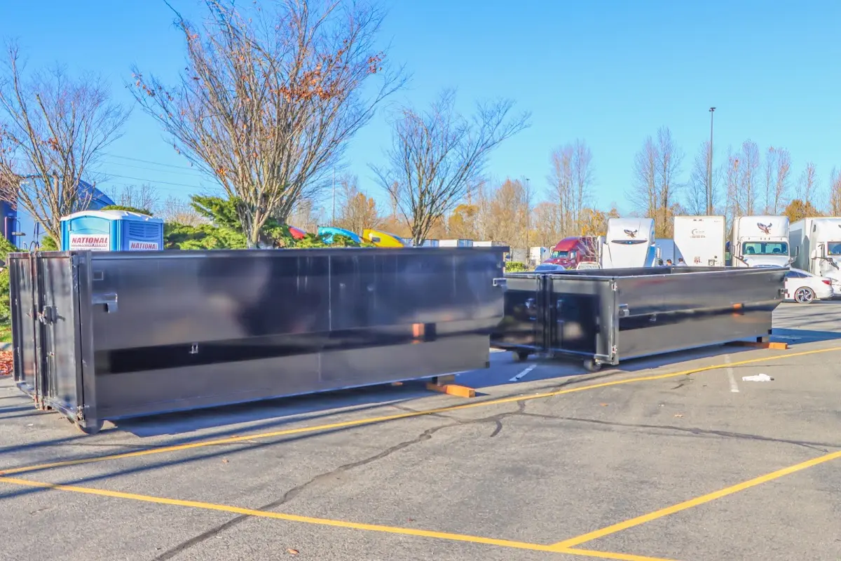 Professional dumpster rental service with roll-off container on residential driveway in Wethersfield